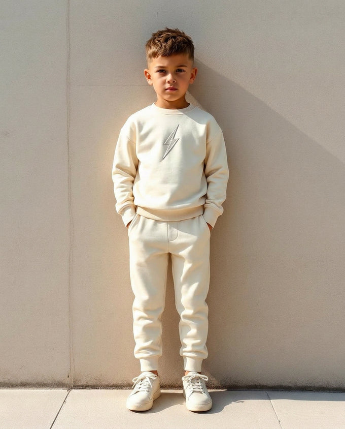 Boy wearing Wild Littles cream bolt joggers